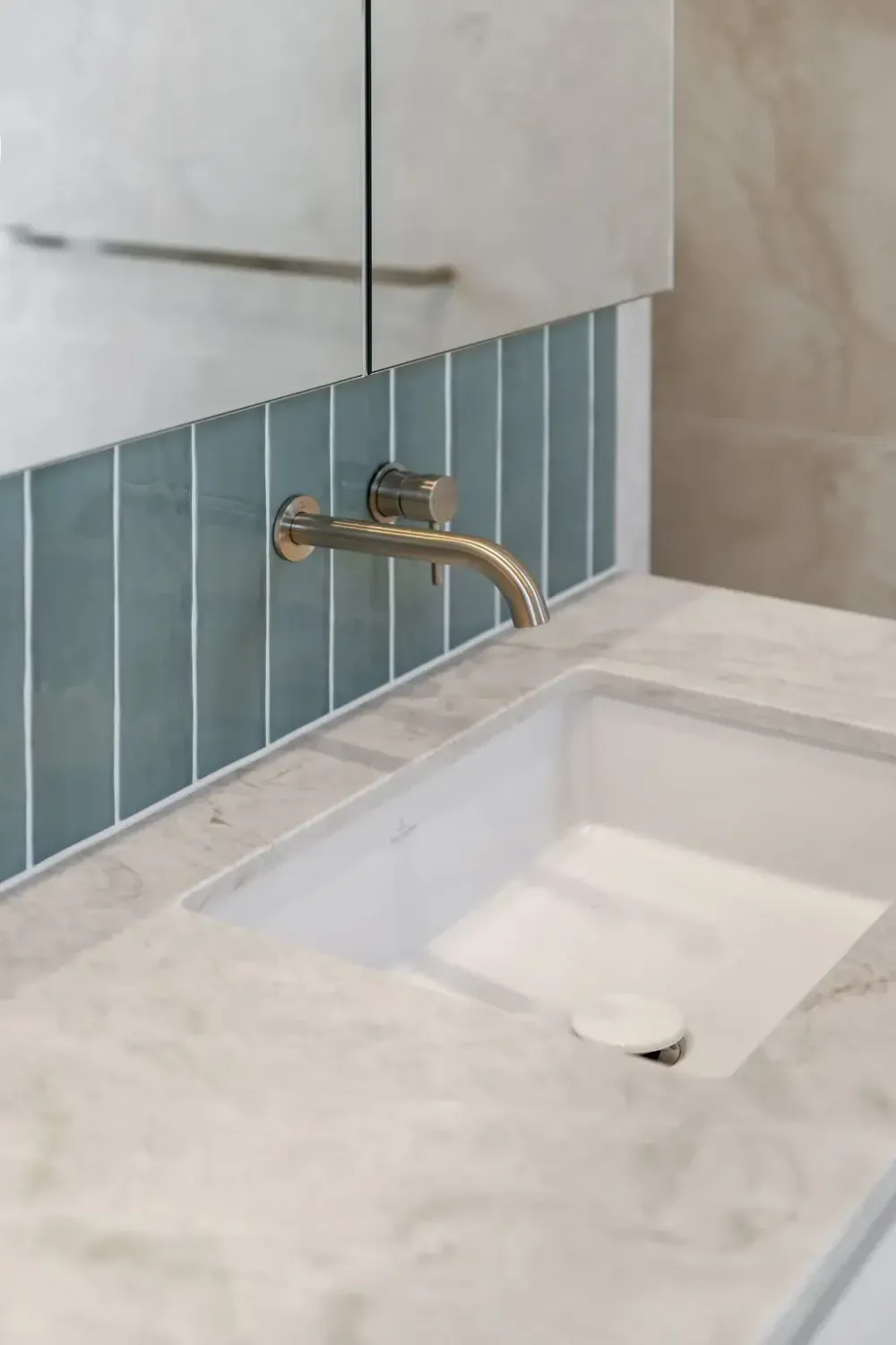 Shower with brass fixtures and stone tiling